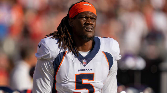Broncos pass rusher Randy Gregory looks on without a helmet before a game.